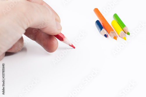 Colour pencils in hand isolated on white background.Copy space