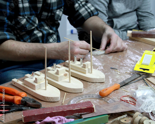 Models of wooden ships on the desktop. Master class in studio