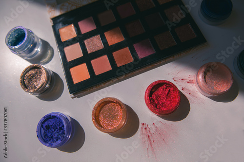 Makeup brushes and color palete on white background