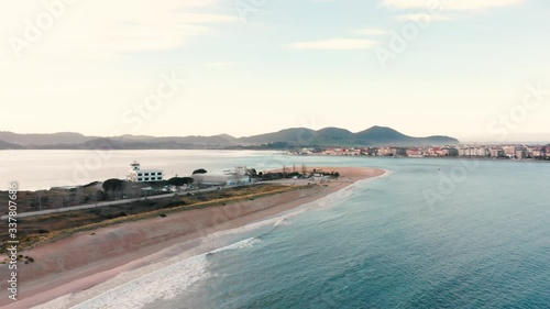 Aerial drone view of a beach bay sunset with dunes in Puntal, Laredo. Ideal for surfing.