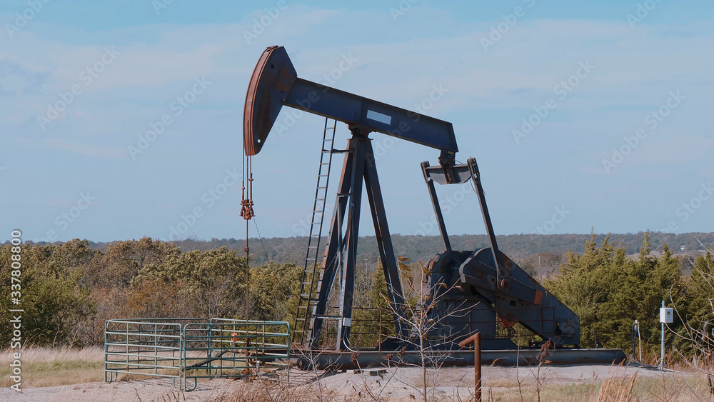 Oil pump in the countryside of Oklahoma - Pump jack - USA 2017 Oil pump in the countryside of Oklahoma - Pump jack - USA 2017