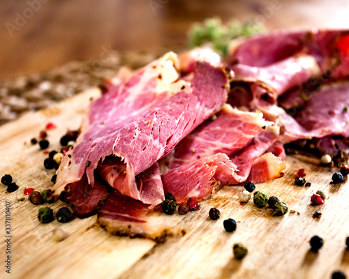 Sliced Deli Pastrami on wooden board