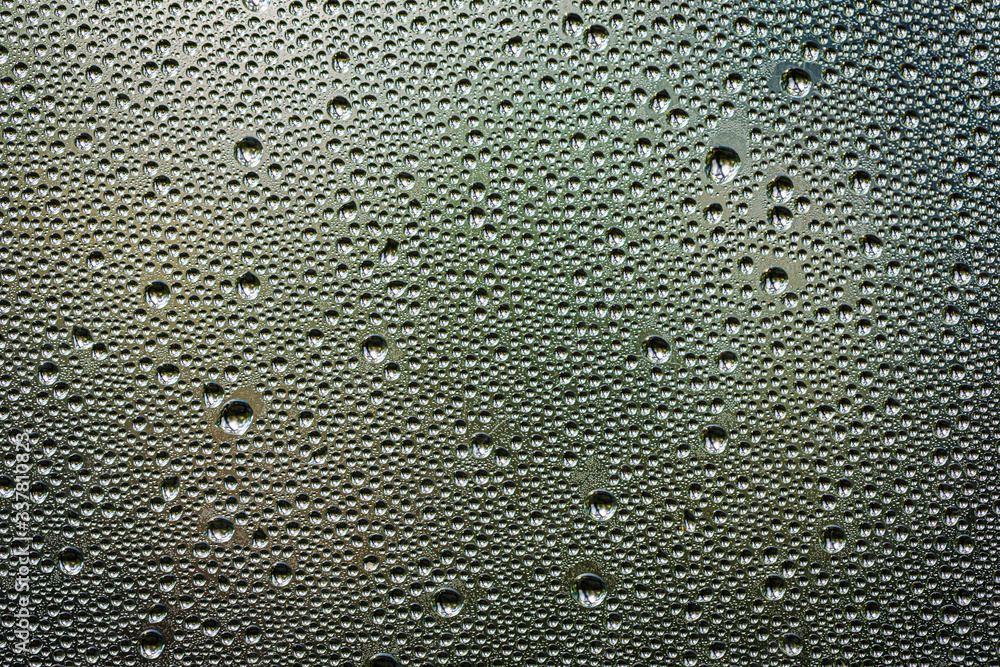 Drops of water after the rain on a glass panel with the sky above Drops of water after the rain on a glass panel with the sky above