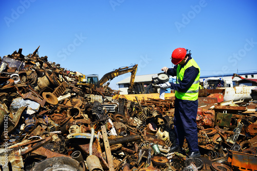 Worker on junkyard. Copy space available.