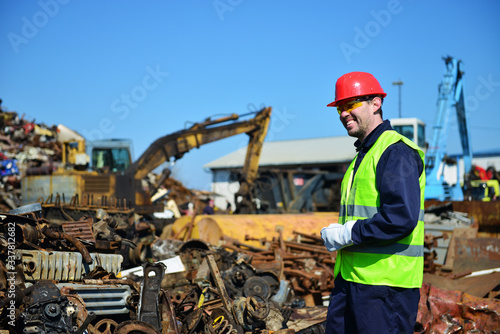 Worker on junkyard. Copy space available.