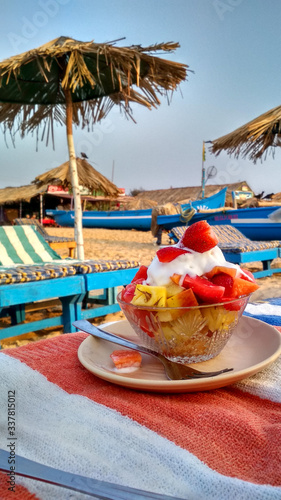 Fototapeta Naklejka Na Ścianę i Meble -  Fruit salad and beach umbrella