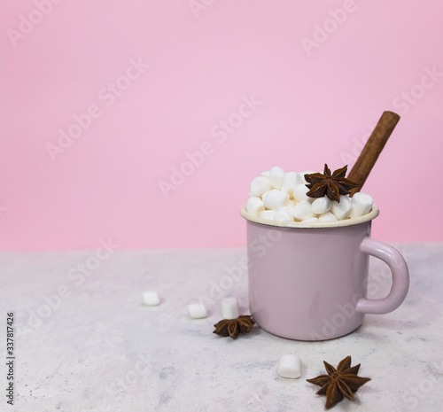 marshmallows in enameled mug with  star anise and cinnamon stick