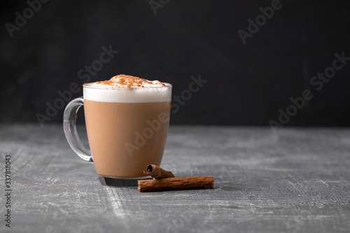 Fotografija Side view of delicious cappuccino coffee with milk foam sprinkled with cinnamon