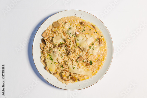 Risotto with mushrooms and cheese served on a restaurant table