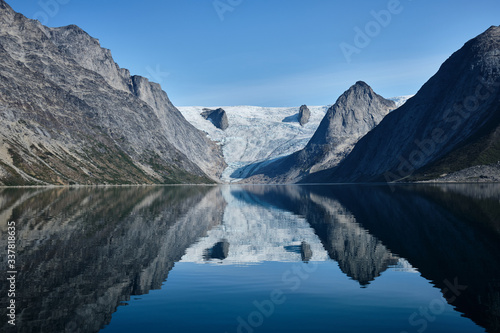 Glacier and mountain reflection in the fjord