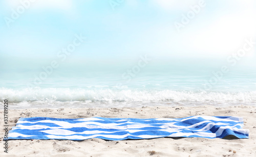 Fototapeta Naklejka Na Ścianę i Meble -  Beach towel on sen sea view, empty space advertisement display,summer backdrop.