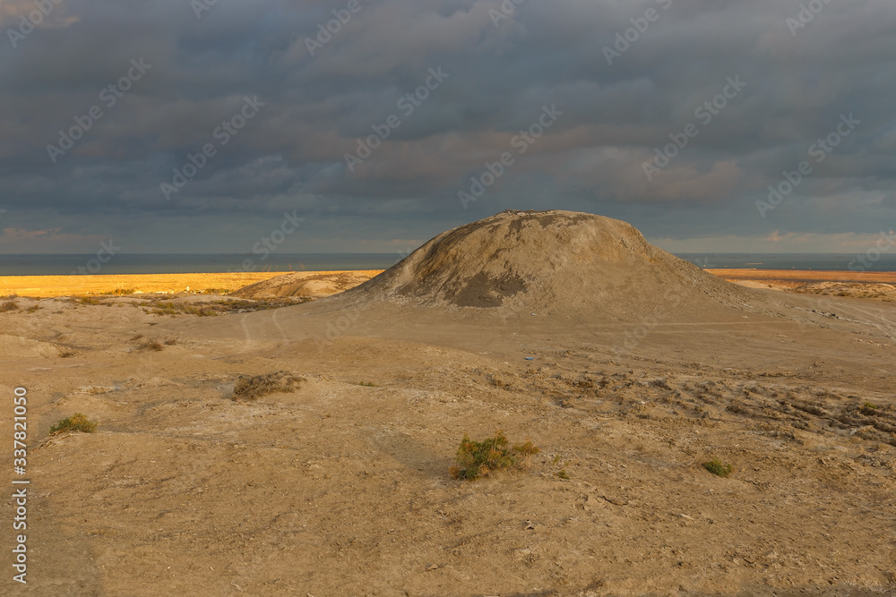 Mud volcanoes of Gobustan in Azerbaijan. mud mountain and thunderstorm sky