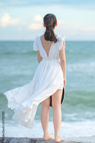 Beautiful women in white dress happily strolling at the beach  beautiful women dressed in white bride