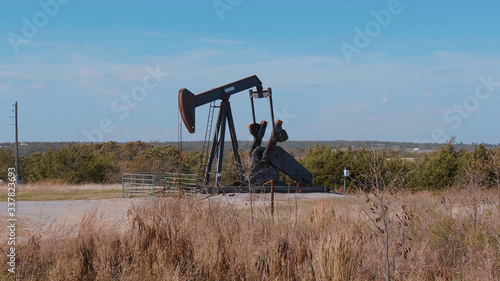 Oil pump in the countryside of Oklahoma - Pump jack - USA 2017