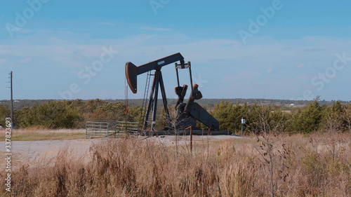 Oil pump in the countryside of Oklahoma - Pump jack - USA 2017 photo