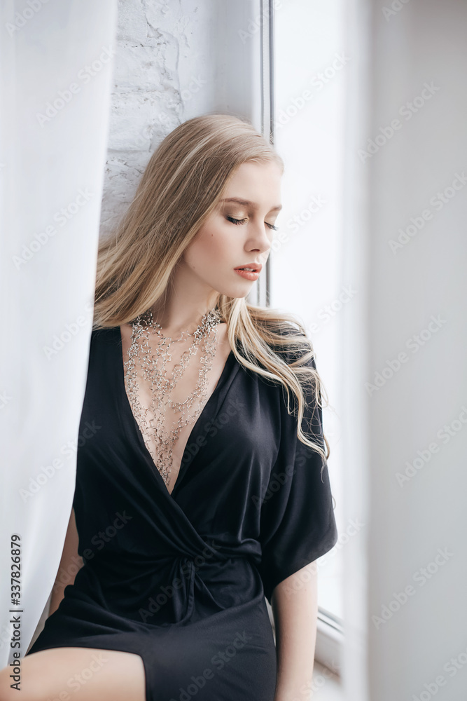 Portrait of beautiful young blonde girl with makeup in black fashion clothes Portrait of beautiful young blonde girl with makeup in black fashion clothes