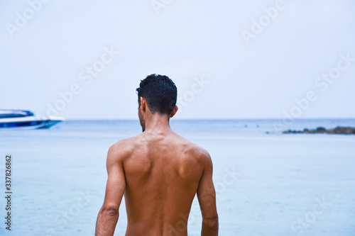 back view of young man in bikini. 