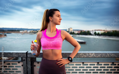 Jogging. Young woman resting after training outdoors. Fitness, sport, lifestyle concept