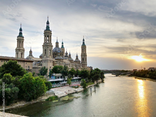 The Cathedral-Basilica of Our Lady of the Pillar, a Roman Catholic church in the city of Zaragoza, in Aragon, Spain, on river Ebro seen by the Old Stone bridge at sunset