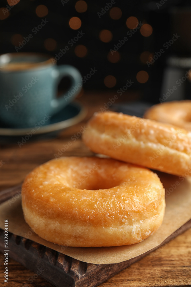 Sweet delicious glazed donuts on wooden table Sweet delicious glazed donuts on wooden table