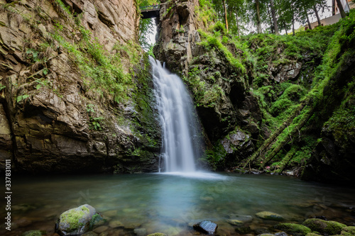 Long exposure photograph of mountain waterfall. Landscape of Miedzygorze  Sudety  Poland.