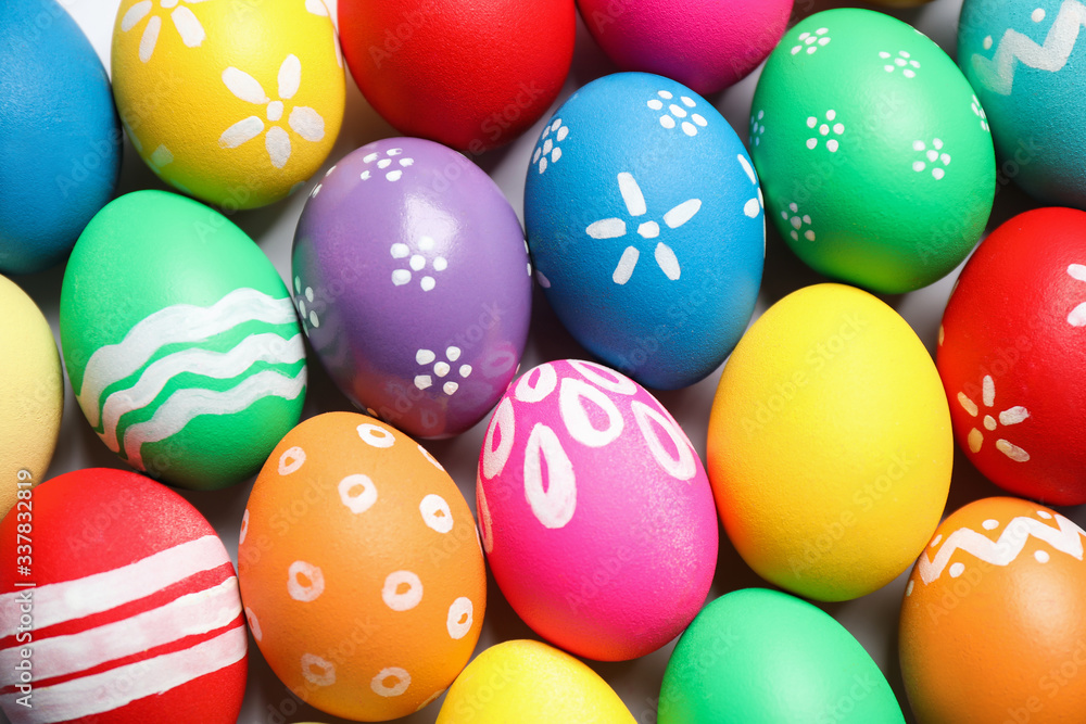 Colorful Easter eggs with different patterns as background, top view