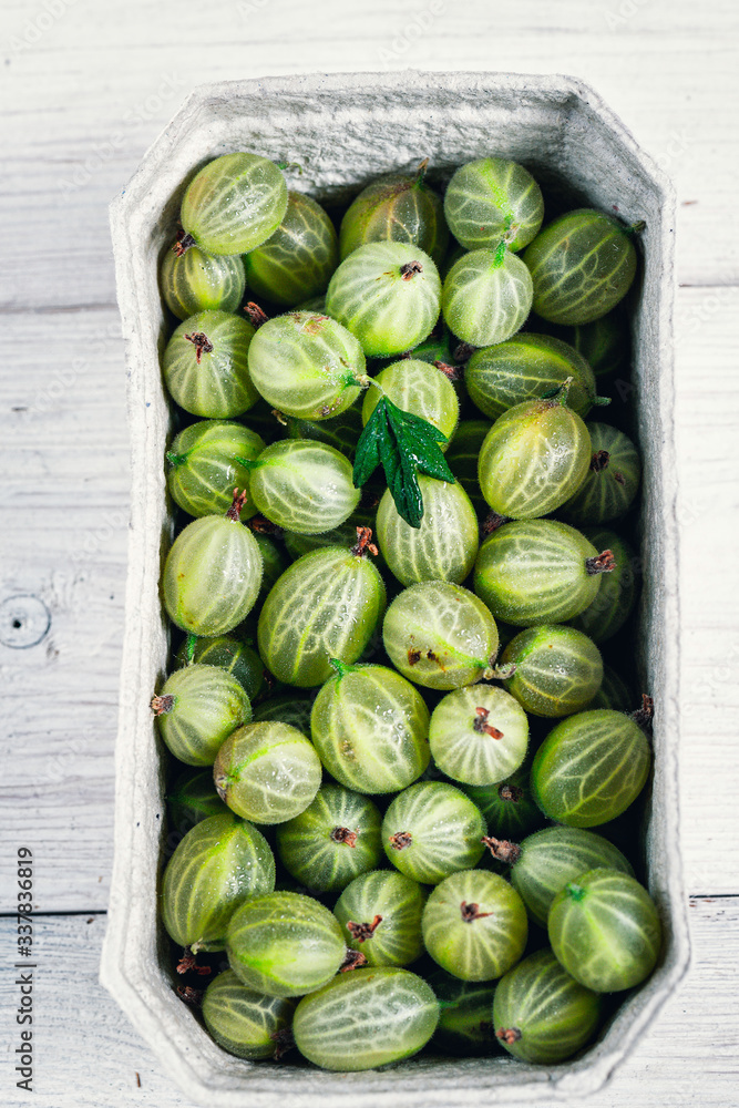Set of organic gooseberry. Gooseberries fruits in paper baskets. Sweet and juicy berry. Top view. Set of organic gooseberry. Gooseberries fruits in paper baskets. Sweet and juicy berry. Top view.