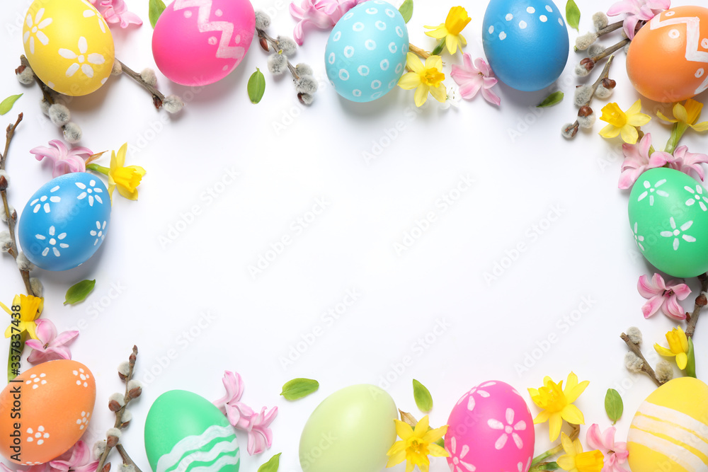 Frame made with Easter eggs on white background, flat lay. Space for text