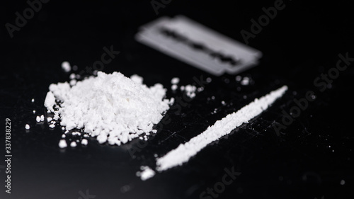 Cocaine on a dark plate (close-up shot)