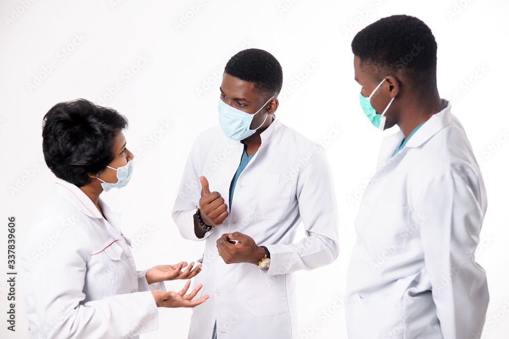 A consultation of doctors who discuss the diagnosis. Doctors on a white background. A consultation of doctors who discuss the diagnosis. Doctors on a white background.