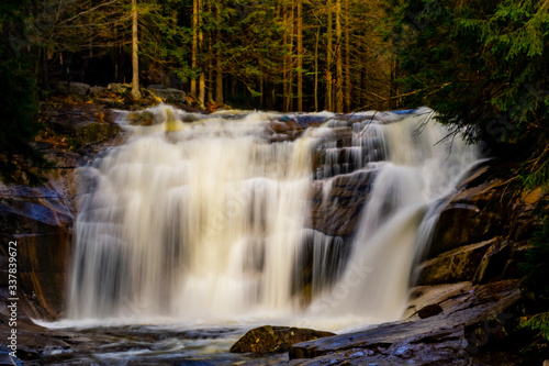 Vivid view of 'Mumlavský vodopád' waterfall in Harrachov, Czech Republic. Beautiful scenery, blurred, soft water. 