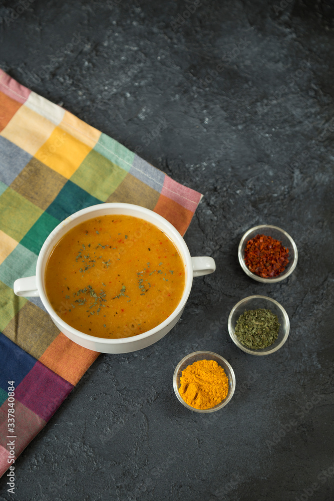 The Tarhana soup on the black background with sauces from Turkey. The Tarhana soup on the black background with sauces from Turkey.