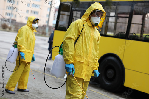 Workers disinfecting bus at bus depot. Lviv, Ukraine.
