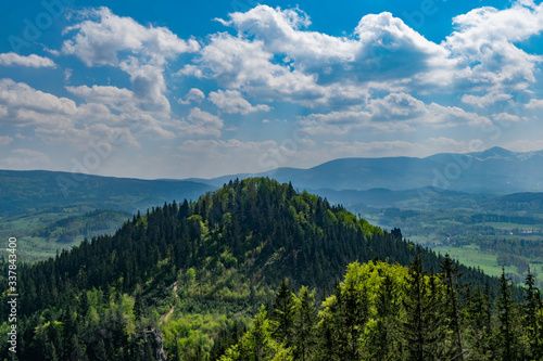 Polish mountains, Krkonoše, Sudetes. View from lookout point. Forest hill, cloudy sky. 