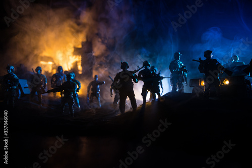 War Concept. Battle scene on war fog sky background, Fighting silhouettes Below Cloudy Skyline at night.