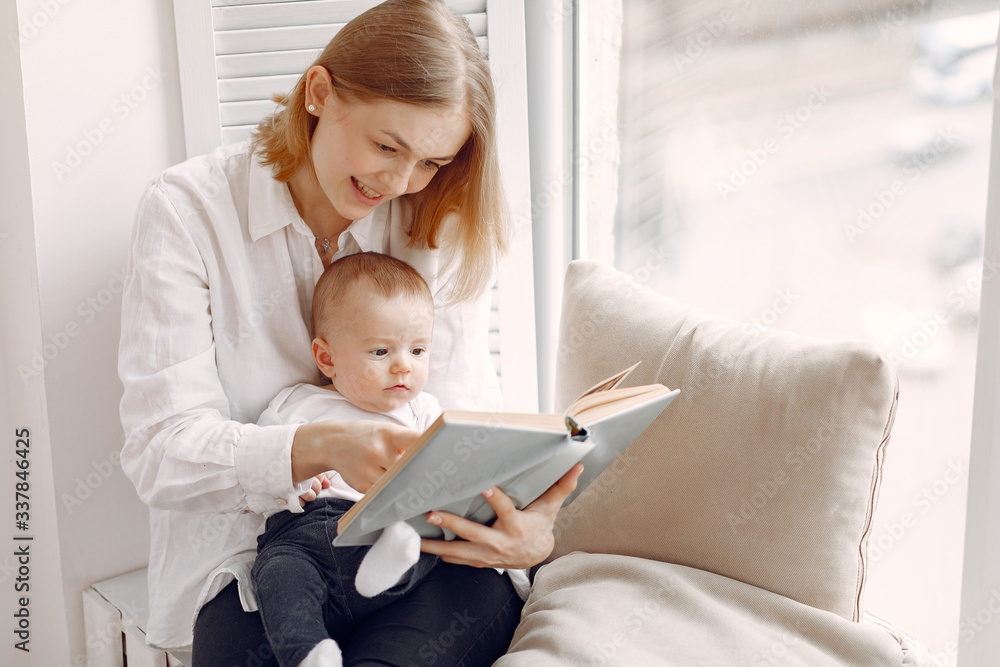 Beautiful woman with child. Woman in a white shirt. Mother reading a book for son. Beautiful woman with child. Woman in a white shirt. Mother reading a book for son.