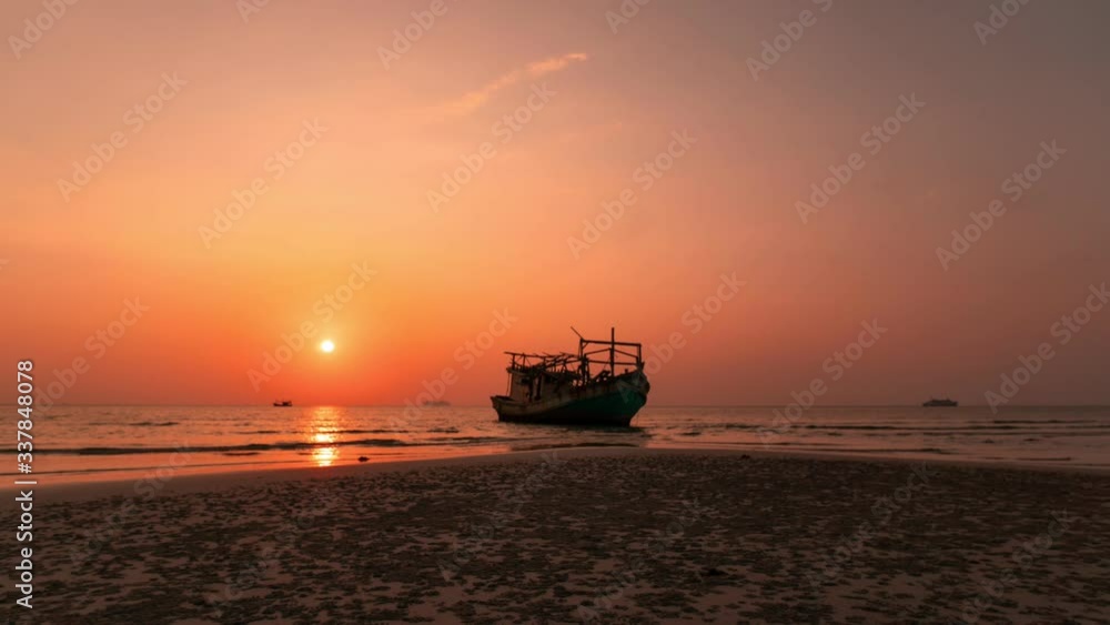 Colourful sunset behind the boat at the beach in Thailand. Timelapse of the sun that goes down at the seashore near the ocean. Concept of vacation at the beach and travelling. Colourful sunset behind the boat at the beach in Thailand. Timelapse of the sun that goes down at the seashore near the ocean. Concept of vacation at the beach and travelling.