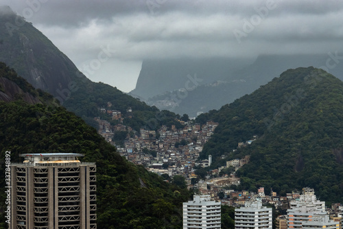 View of Brazilian city showing favelas, hotels, condos, apartments in a mountain range in Rio de Janeiro on a cloudy day. photo