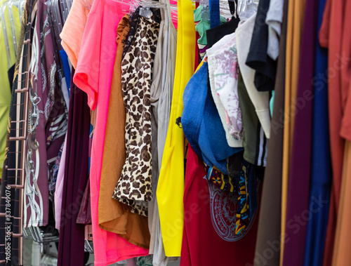 Women's clothes hanging in a wardrobe