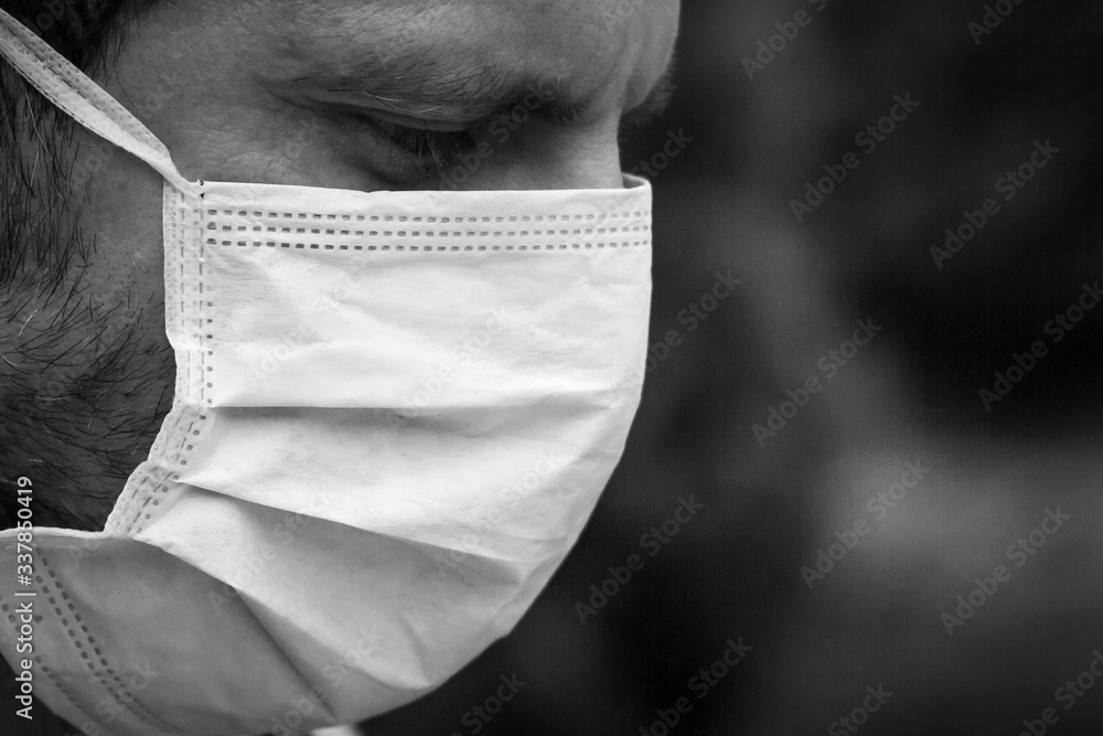 Man suffering of covid pandemic in Madrid, Spain with a mask on his face