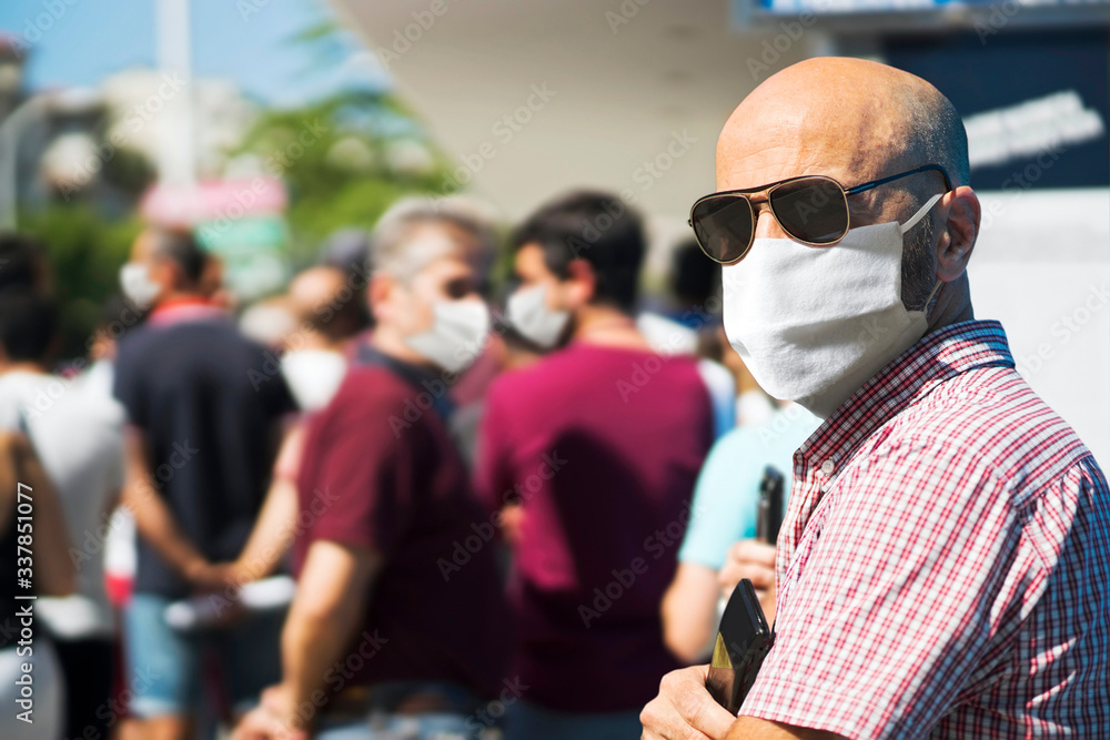 people queue with mask for coronavirus  in line up , draggle