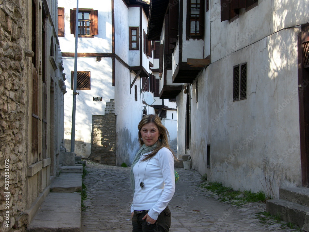 A beautiful tourist woman in the streets of an historical town center