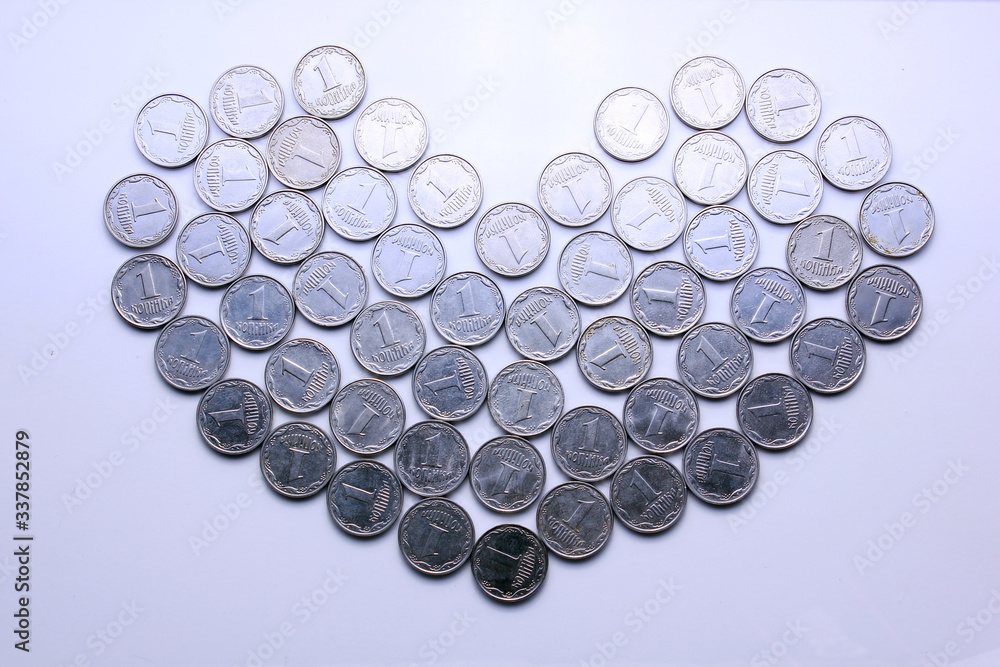 heart folded from Ukrainian coins of 1 and 2 kopecks on a white background top view heart folded from Ukrainian coins of 1 and 2 kopecks on a white background top view