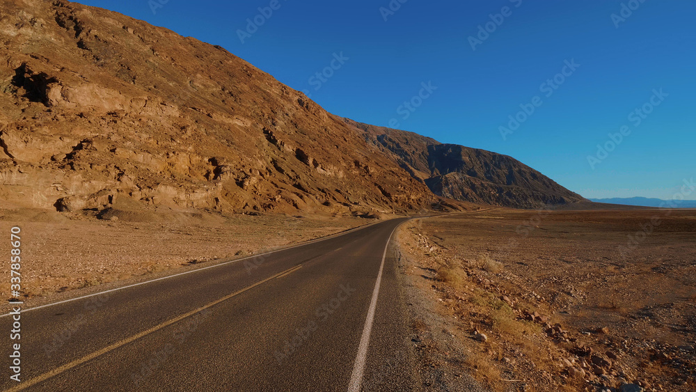 Scenery road through the amazing landscape of Death Valley National Park California - USA 2017 Scenery road through the amazing landscape of Death Valley National Park California - USA 2017
