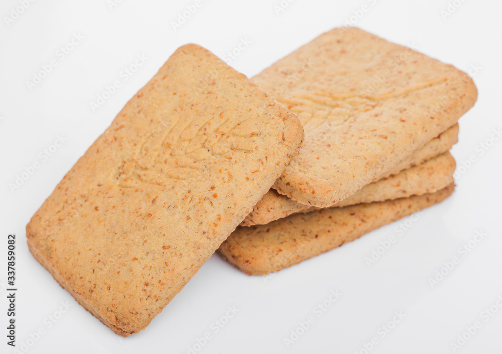 Stack of square organic crispy wheat and five grain salty crackers on white. Top view Stack of square organic crispy wheat and five grain salty crackers on white. Top view