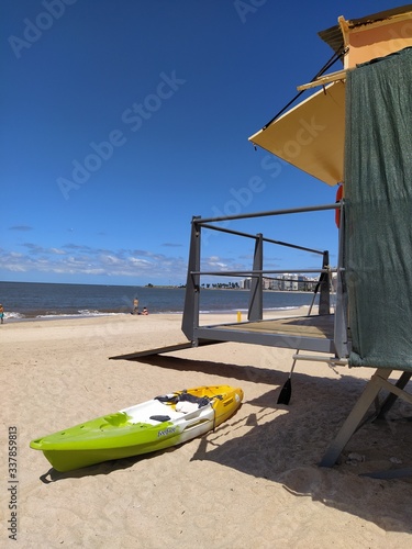 Kayaking and lifeguard stand on the beach photo