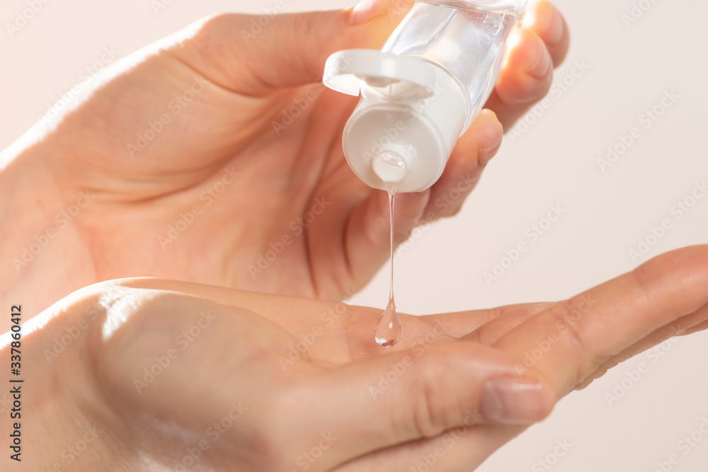 Woman using sanitizer antiseptic closeup view - obrazy, fototapety, plakaty 