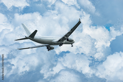 Passenger plane is ready for landing in the cloudy sky.