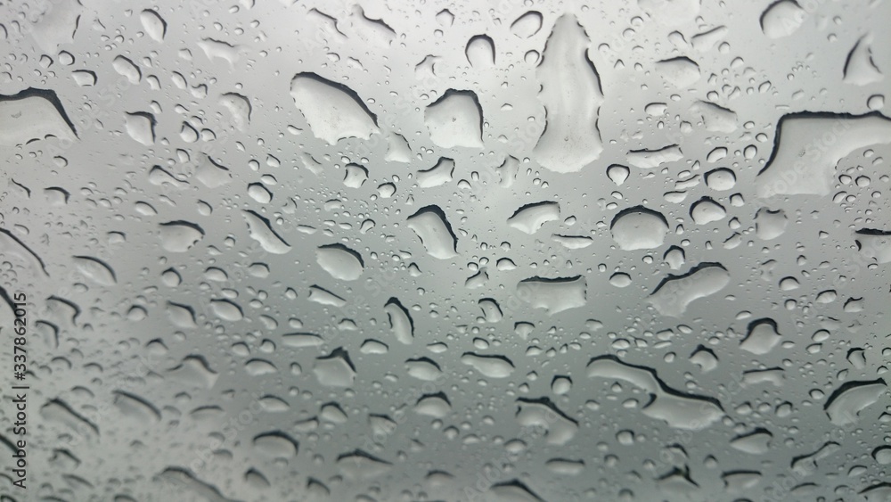 Droplets on glass in a rainy weather Droplets on glass in a rainy weather