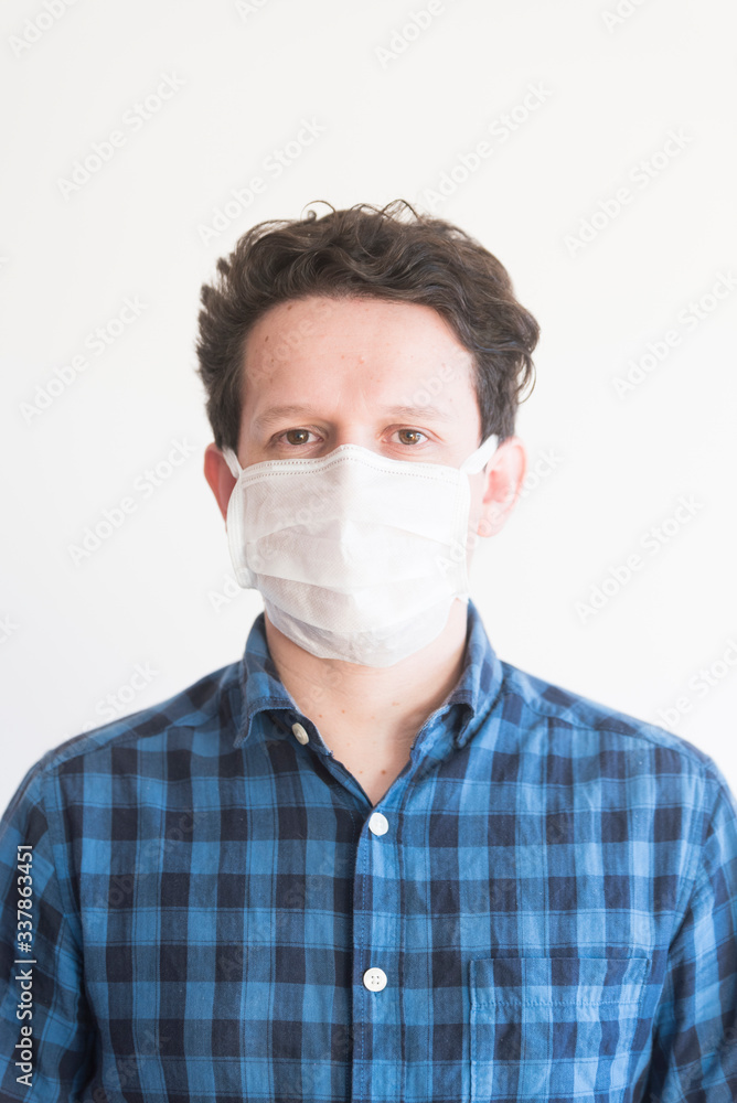 Man wearing a disposable face mask, to prevent the spread of the coronavirus Man wearing a disposable face mask, to prevent the spread of the coronavirus
